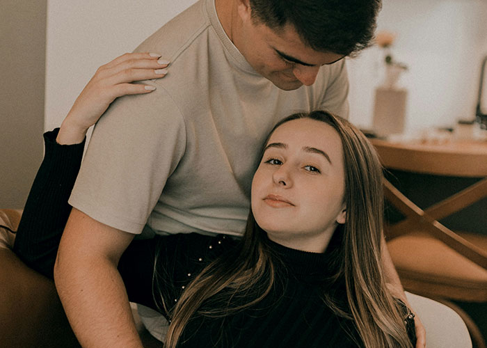 Young couple embracing in a cozy home setting, reflecting on things women stopped pretending they like after 30.