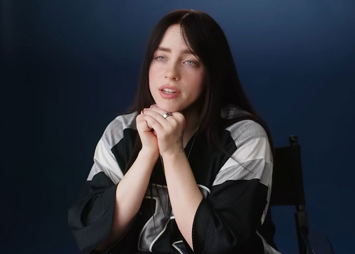 Young woman with long dark hair speaking in an interview about people who knew celebrities before fame reveals.