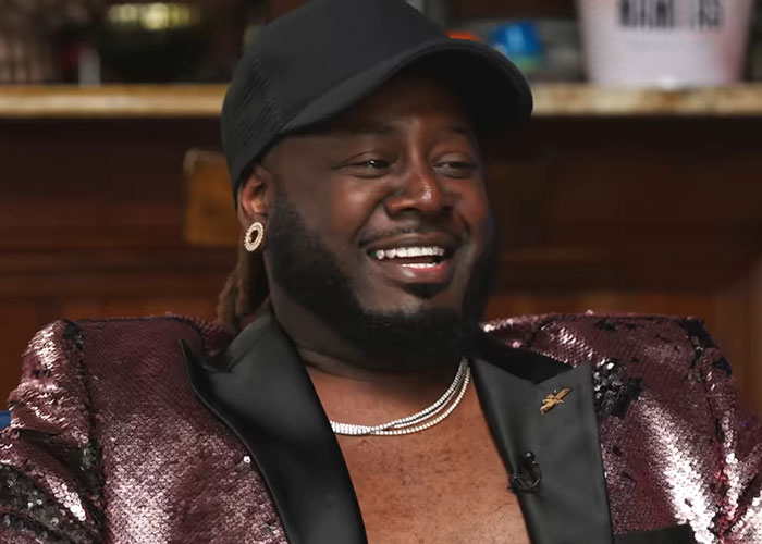 Man in a sequined jacket and cap smiling during an interview with people who knew celebrities before fame.