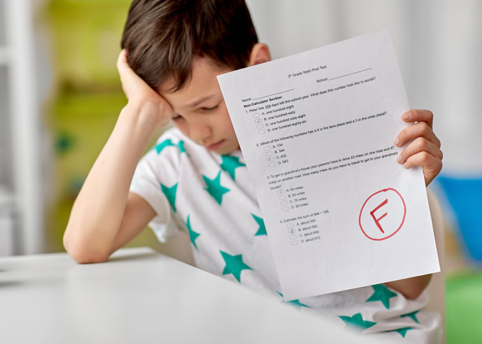 Young student frustrated with a failed test, illustrating teacher catching cheaters by handing out multiple quiz versions.