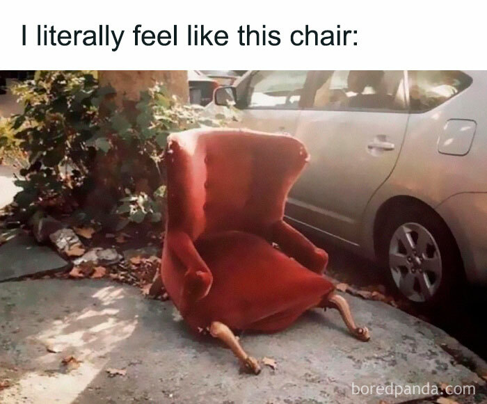 Worn-out red chair with broken legs on the sidewalk, humorous random meme for when your brain needs a break.