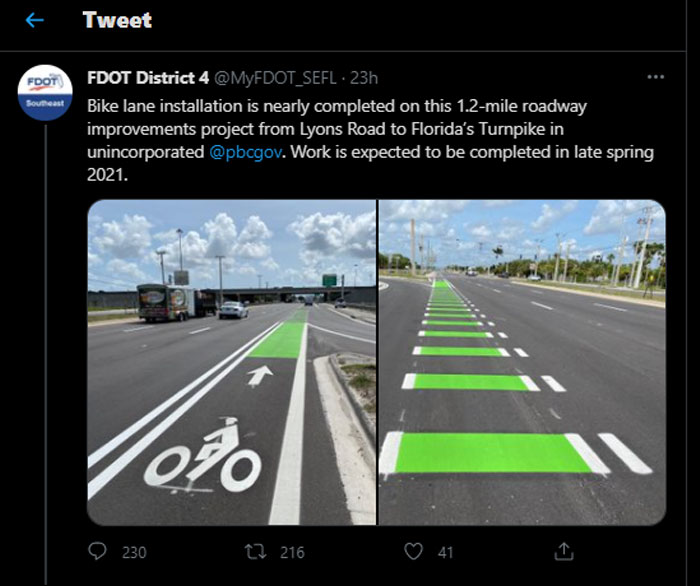 Bike lane with green markings and unusual road design elements creating potential dangerous designs on a busy roadway.