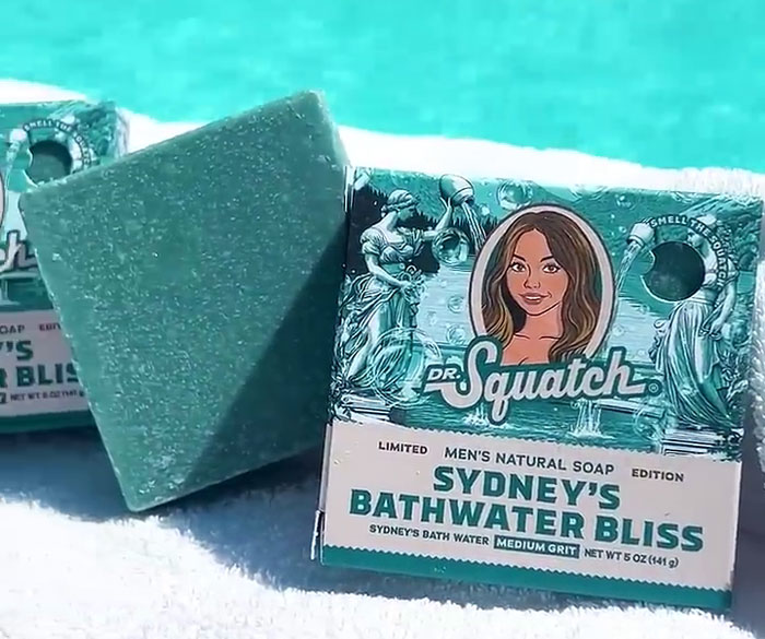 Dr. Squatch Sydney's Bathwater Bliss soap bar displayed outdoors, highlighting Sydney Sweeney bath water soap launch.