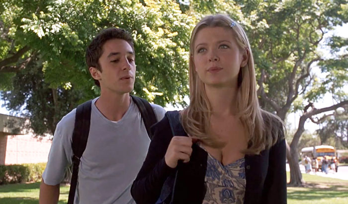 Female American Pie star with blonde hair walking outdoors with a male co-star on a sunny day. Female American Pie star with blonde hair walking outdoors with a male co-star on a sunny day.