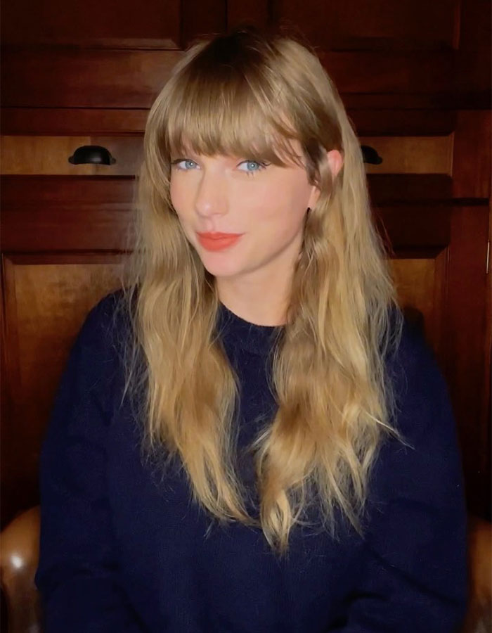 Taylor Swift with long blonde hair and blue eyes, posing indoors, related to Trump claims about her being no longer hot.