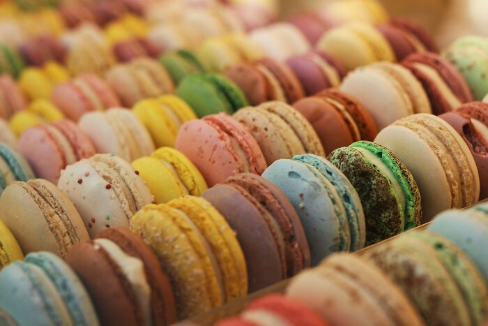 Colorful macarons arranged in rows, showcasing wild cooking opinions on creative and unique dessert presentations.