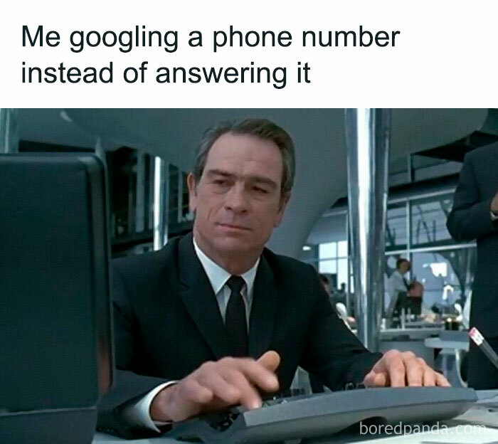 Man in a suit typing on keyboard, illustrating memes encapsulating the human experience and modern habits.