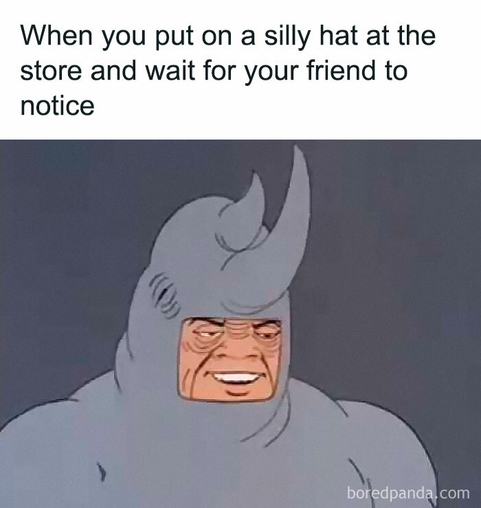 Man wearing a silly rhino hat waiting for friend to notice, a meme encapsulating the human experience humorously.