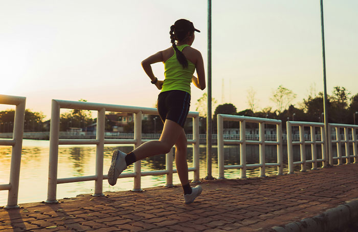 Woman running by the water at sunset, illustrating one of the experiences that made people say never doing that again.