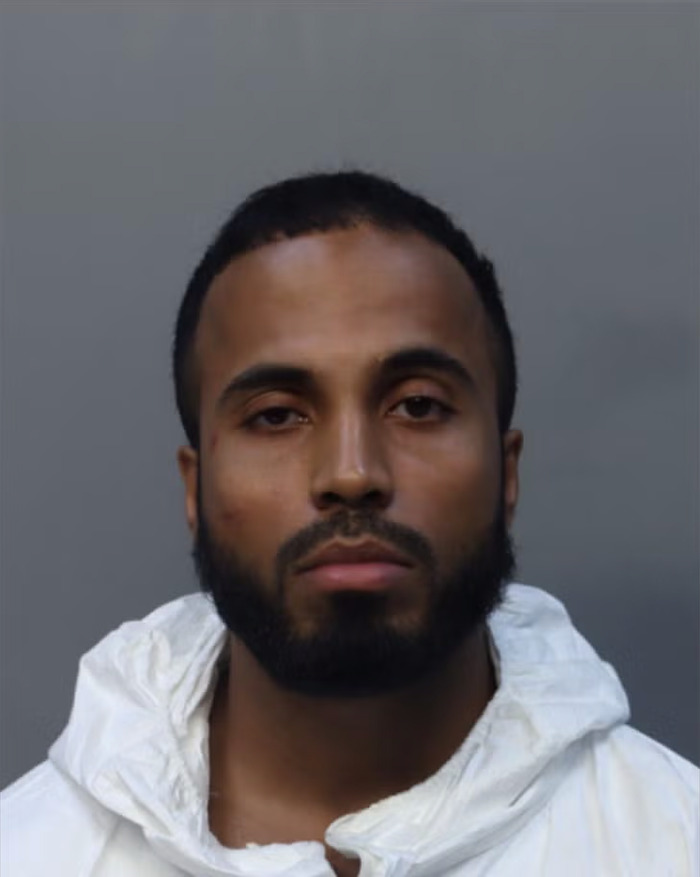 Young man with a beard in a white jacket, related to toddler found covered in blood after influencer slays mom case.