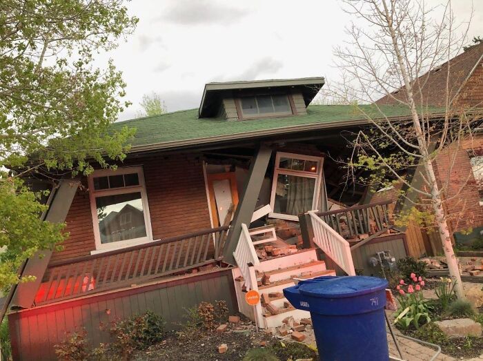 House with a collapsed porch and damaged facade after failed renovation attempt, illustrating saving on renovations regrets.