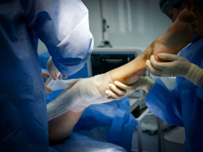 Medical professionals examining a patient’s leg, highlighting unhealthy conditions and concerning health practices.