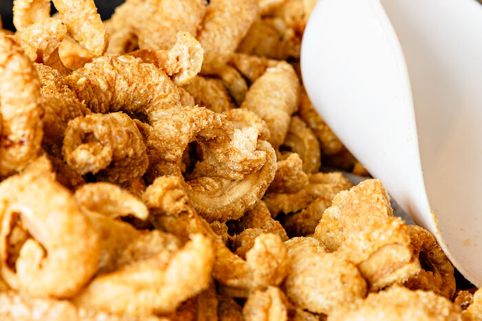 Close-up of crispy pork rinds showing an example of incredibly unhealthy things people have eaten.