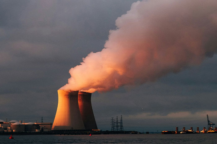 Cooling towers at a power plant emitting steam, illustrating wild analogies healthcare workers use to explain medical problems.