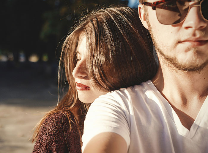Close-up of two people outdoors with one leaning on the other's shoulder, illustrating healthcare workers using analogies.