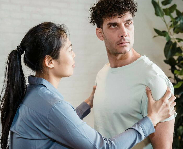 Wife asking husband to help check on elderly parents’ home while he refuses and looks frustrated indoors. Wife asking husband to help check on elderly parents’ home while he refuses and looks frustrated indoors.