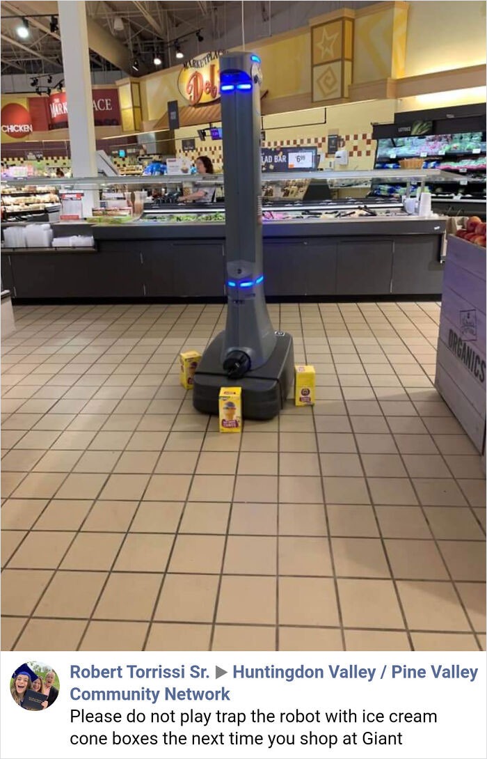 Robot cleaning in grocery store trapped by ice cream cone boxes, a hilarious tech fail in everyday computer skills.