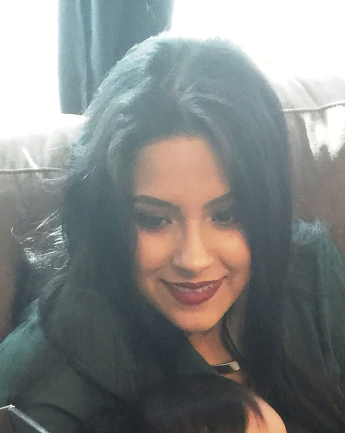 Woman with dark hair sitting on a couch, smiling softly, related to mom who locked 7YO starving child in closet case.