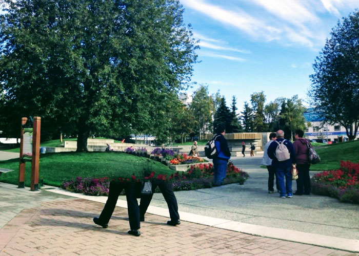 Person walking with their legs appearing detached due to weird things on Google Earth optical illusion in a park setting.