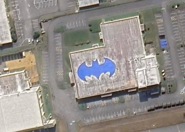 Aerial view of a building rooftop shaped like the Batman symbol, one of the weird things on Google Earth.