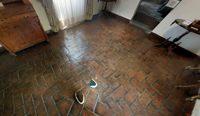 Odd, seemingly upside-down shoes embedded in a brick floor, showcasing weird things on Google Earth that prompt disbelief.