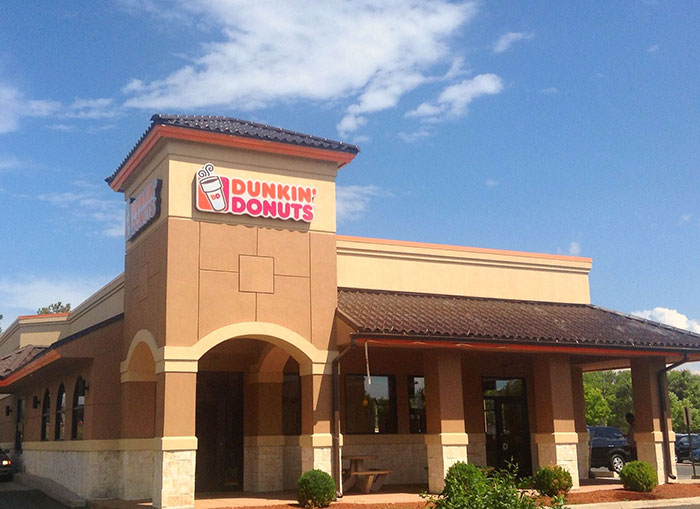 Dunkin Donuts storefront on a sunny day, related to con artist Karen stopped by customer loopholes. Dunkin Donuts storefront on a sunny day, related to con artist Karen stopped by customer loopholes.
