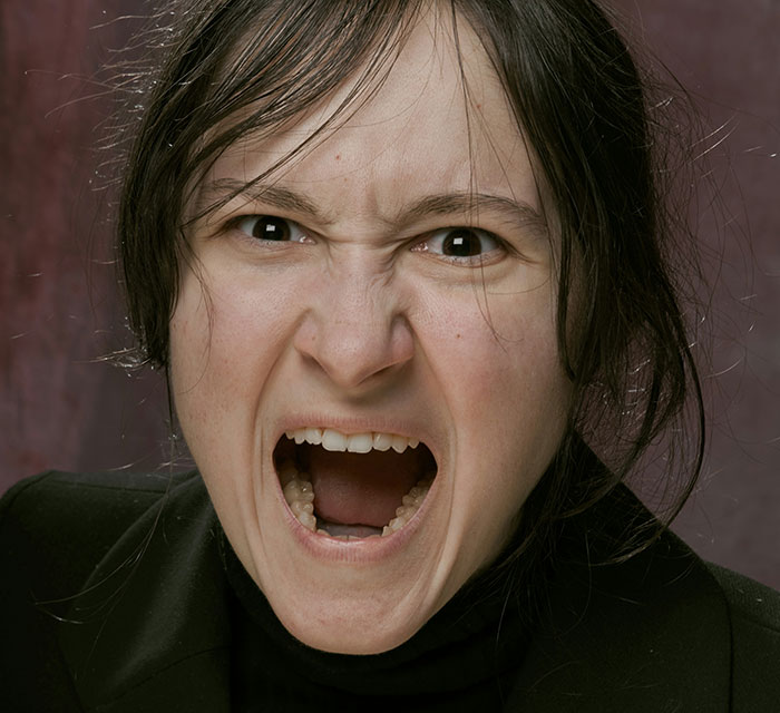 Woman with an intense expression emphasizing unhinged safety habits that might actually save lives in a close-up portrait.