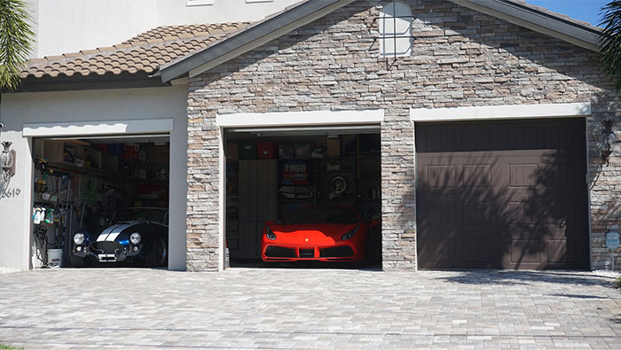 Luxury sports cars parked inside a spacious three-car garage, showcasing a glimpse into the world of the ultra wealthy.