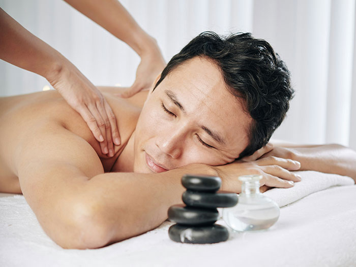 Man receiving a relaxing massage as part of a glimpse into the world of the ultra wealthy lifestyle and luxury experiences.