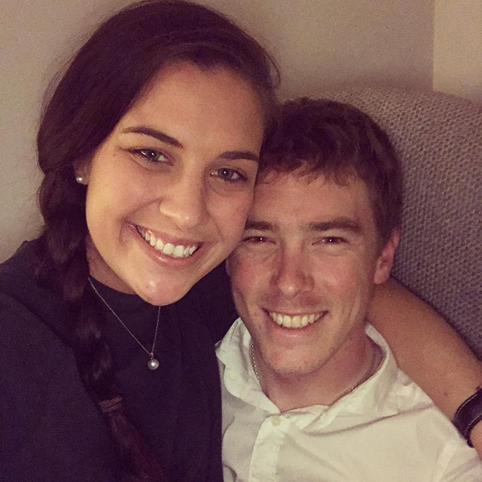 Smiling couple close together, representing the cyclist and late Olympian wife in a heartfelt apology after a fatal crash.