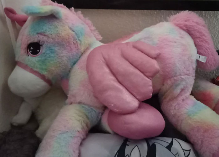 Large pastel-colored stuffed unicorn with pink wings, an example of the worst gifts people have ever received.