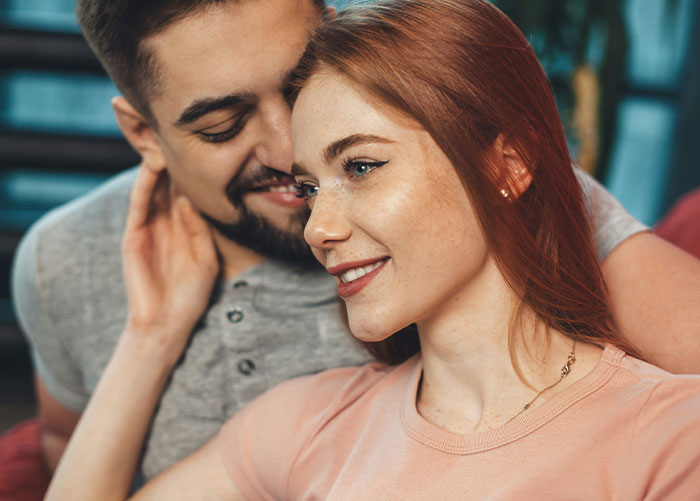 Couple sharing a tender moment indoors, highlighting emotions connected to the worst gifts they’ve ever received.