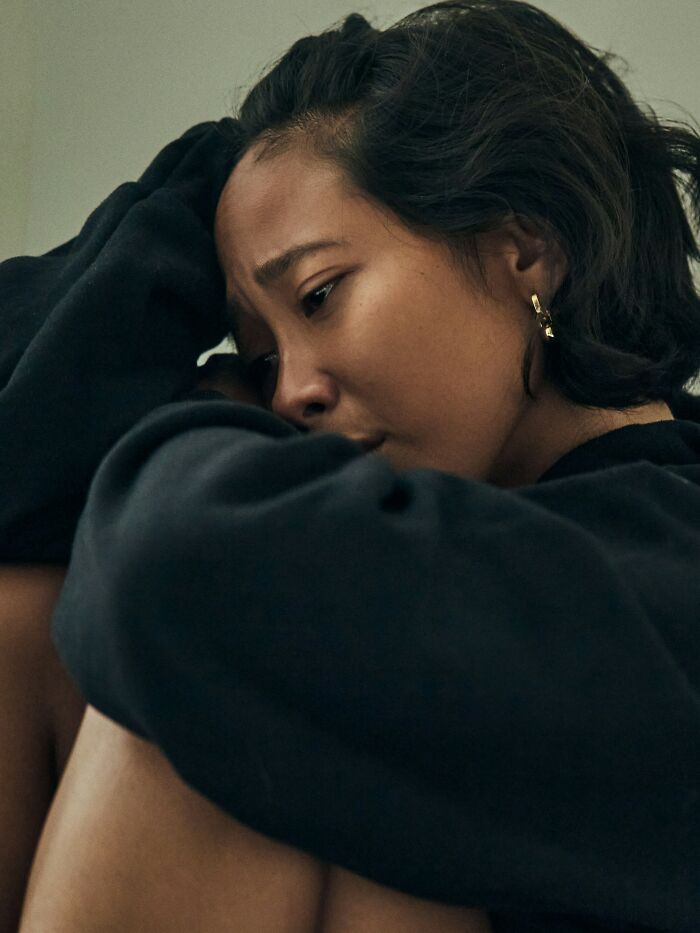 Young woman looking distressed and emotional, reflecting on hurtful things their mom said to them.