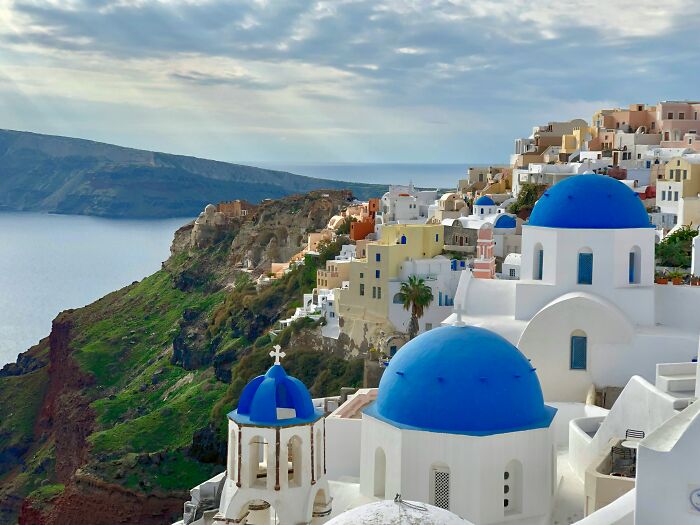 Santorini with iconic blue domes and white buildings showcases must-see wonders that prove the world is still full of magic.