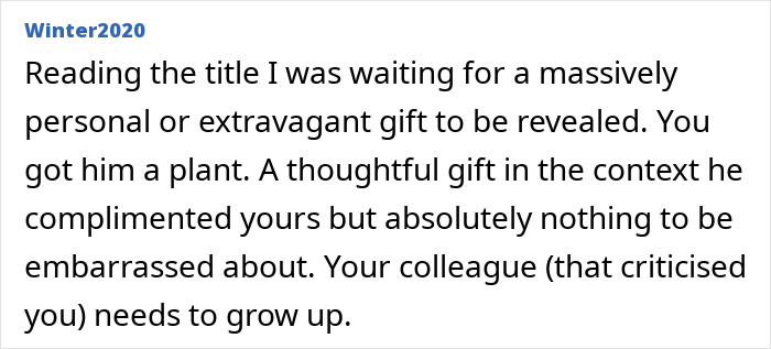 Man gifting a small green plant to his male colleague in an office setting, showing thoughtful workplace gesture.