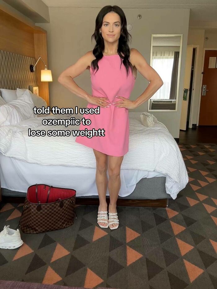 Woman in pink dress posing in hotel room after weight loss using Ozempic, sharing her journey online confidently. Woman in pink dress posing in hotel room after weight loss using Ozempic, sharing her journey online confidently.