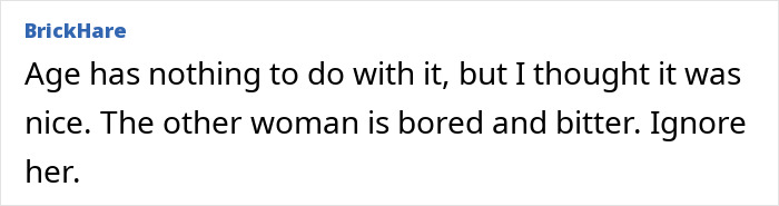 Man gifting a small potted plant to his male colleague in a modern office setting.