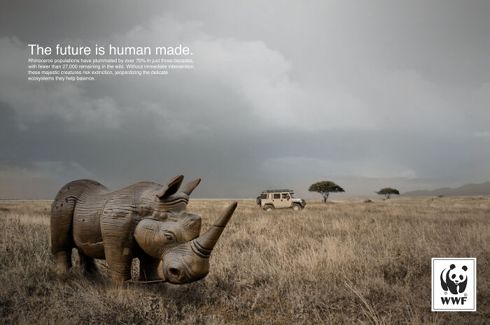 Powerful WWF ad showing a wooden rhino sculpture in a dry savannah highlighting endangered species conservation.