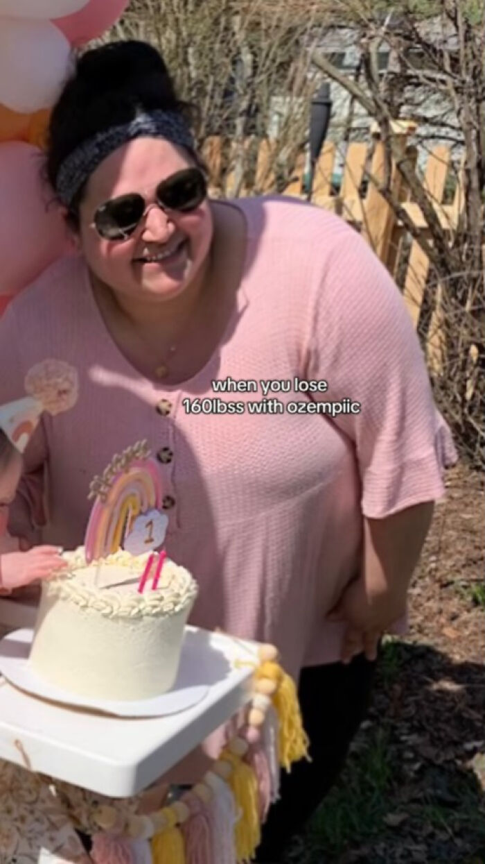 Woman smiling outdoors next to a birthday cake celebrating weight loss using Ozempic, wearing sunglasses and a pink top. Woman smiling outdoors next to a birthday cake celebrating weight loss using Ozempic, wearing sunglasses and a pink top.