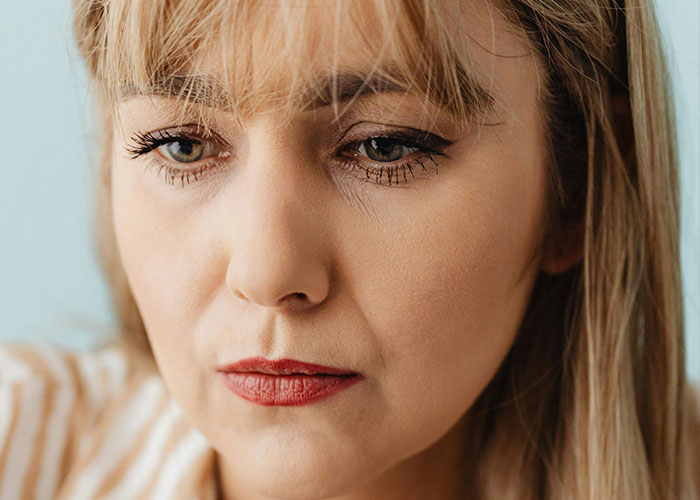 Close-up of a worried mom-to-be thinking about postpartum help from her mom and grandparent balance concerns. Close-up of a worried mom-to-be thinking about postpartum help from her mom and grandparent balance concerns.