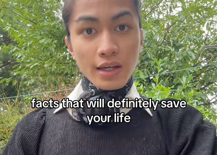 Young person outdoors wearing a black sweater and patterned scarf sharing safe driving facts that might be useful for license holders.