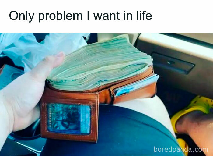 Relatable meme showing a hand holding a wallet stuffed with cash, highlighting a funny life problem.