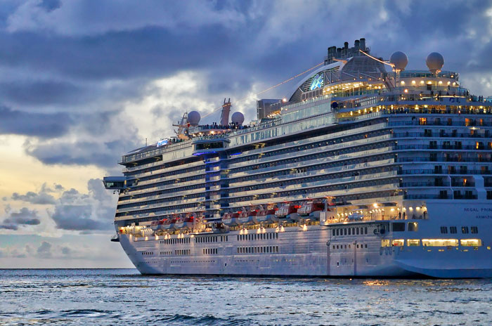 Large cruise ship sailing at dusk with lights on, illustrating a story about poor parenting and potential loss of custody.