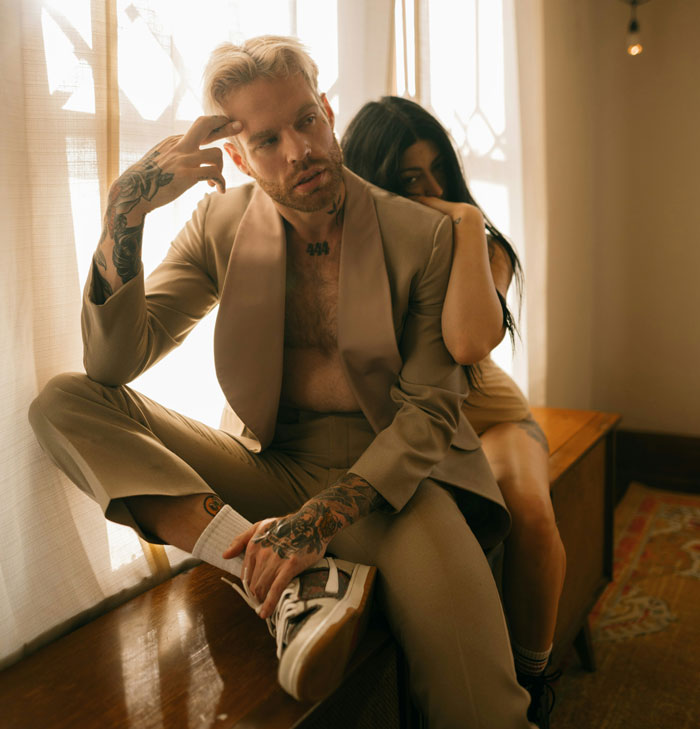 Young couple in a tense moment indoors, illustrating toxic dating trends people weirdly accept as normal behavior.