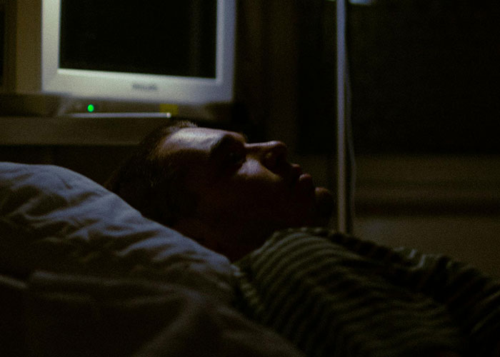 Man lying awake in the dark, reflecting on why they called off their engagement after a betrayal by the best man.