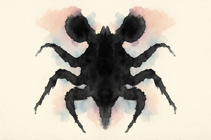 Black symmetrical Rorschach inkblot resembling an insect with colorful pastel background in the ultimate inkblot poll.
