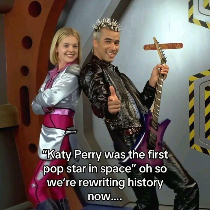 Two people in futuristic outfits pose with a guitar, referencing a pop culture moment related to Millennials and Gen Z.