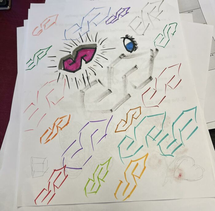 Colorful hand-drawn dollar signs and an eye on white sheets of paper, illustrating connection and creativity in a group setting.