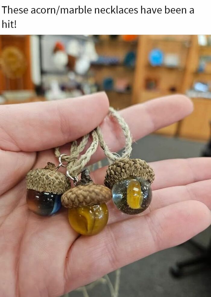 Hand holding acorn and marble necklaces as examples of horrendous DIY projects that needed to be craft shamed.