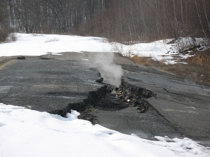 C*****d and steaming road in a snowy forest area, depicting one of the scariest places around the world for brave travelers.